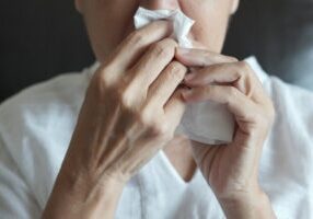 Elderly female robes feeling unwell just caught cold